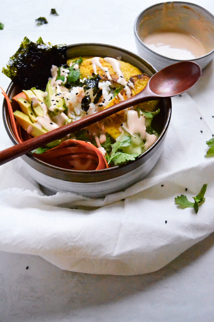 Yellow Tofu Sushi Bowl on Table.