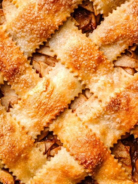 a macro shot of the golden vegan pie crust on the apple pie.