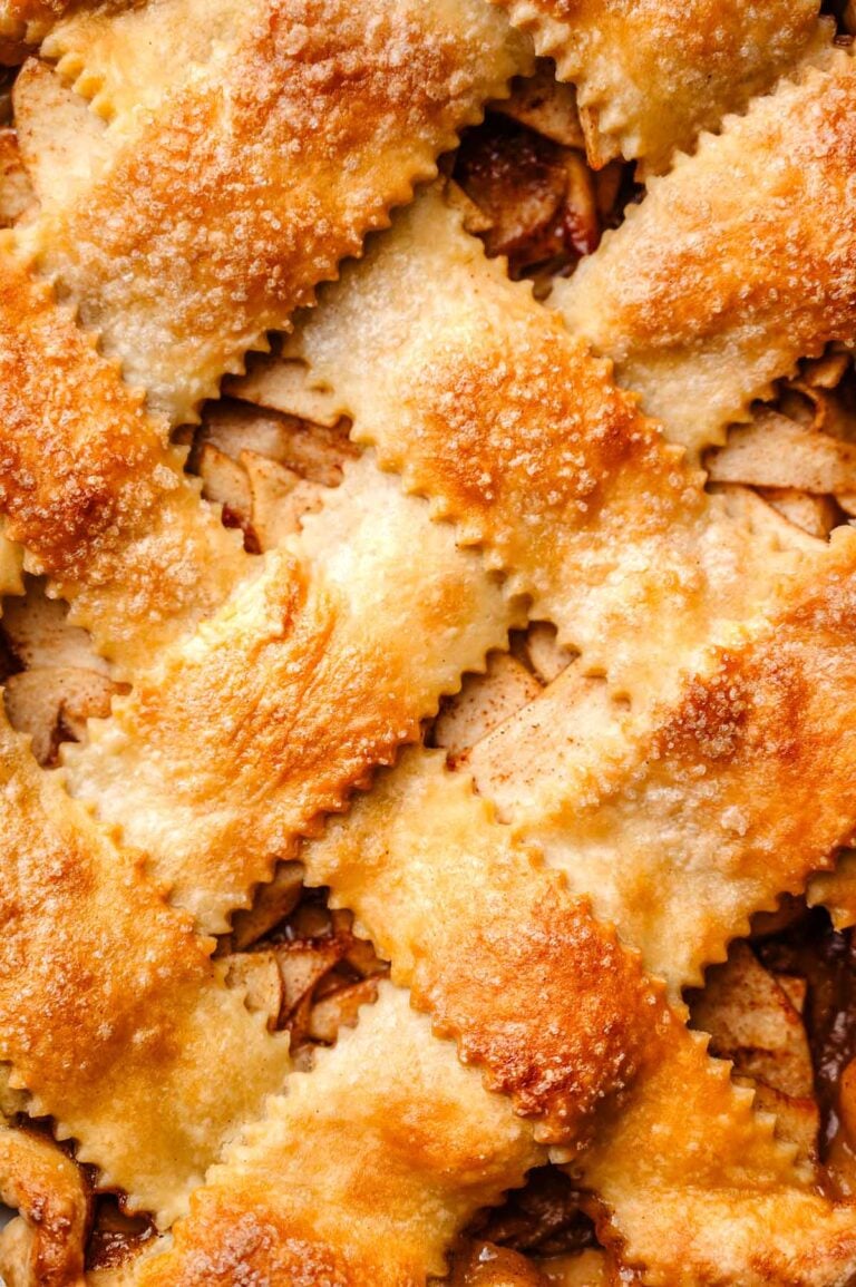 a macro shot of the golden vegan pie crust on the apple pie.