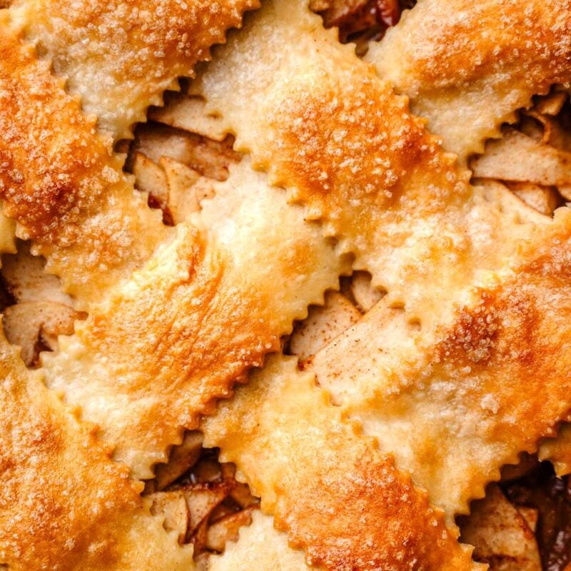 a macro shot of the golden vegan pie crust on the apple pie.