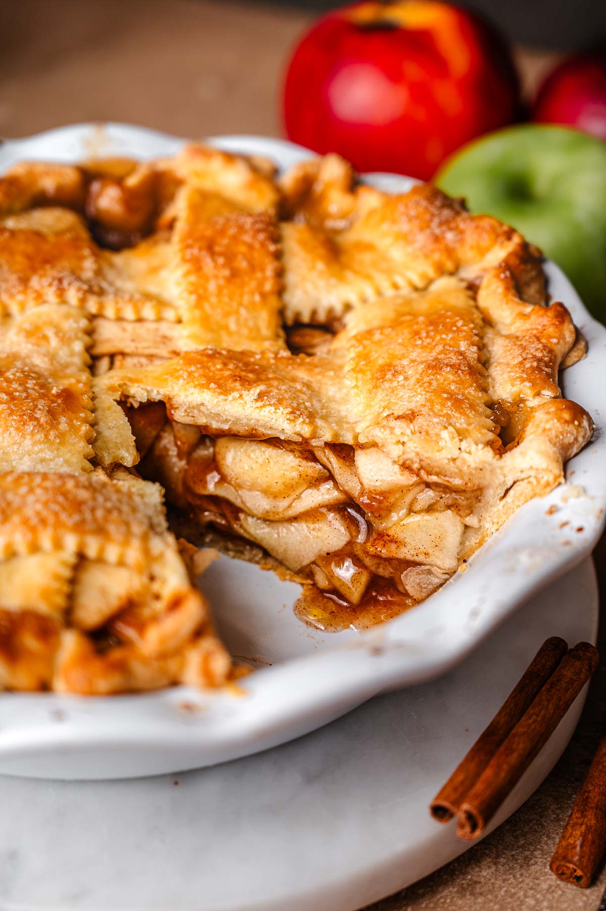 vegan apple pie in a deep dish white ceramic pan.