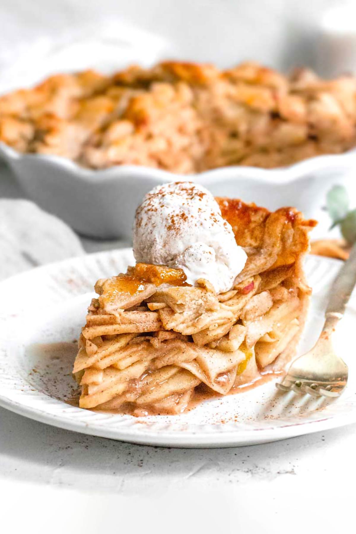 a slice of vegan apple pie with ice cream.