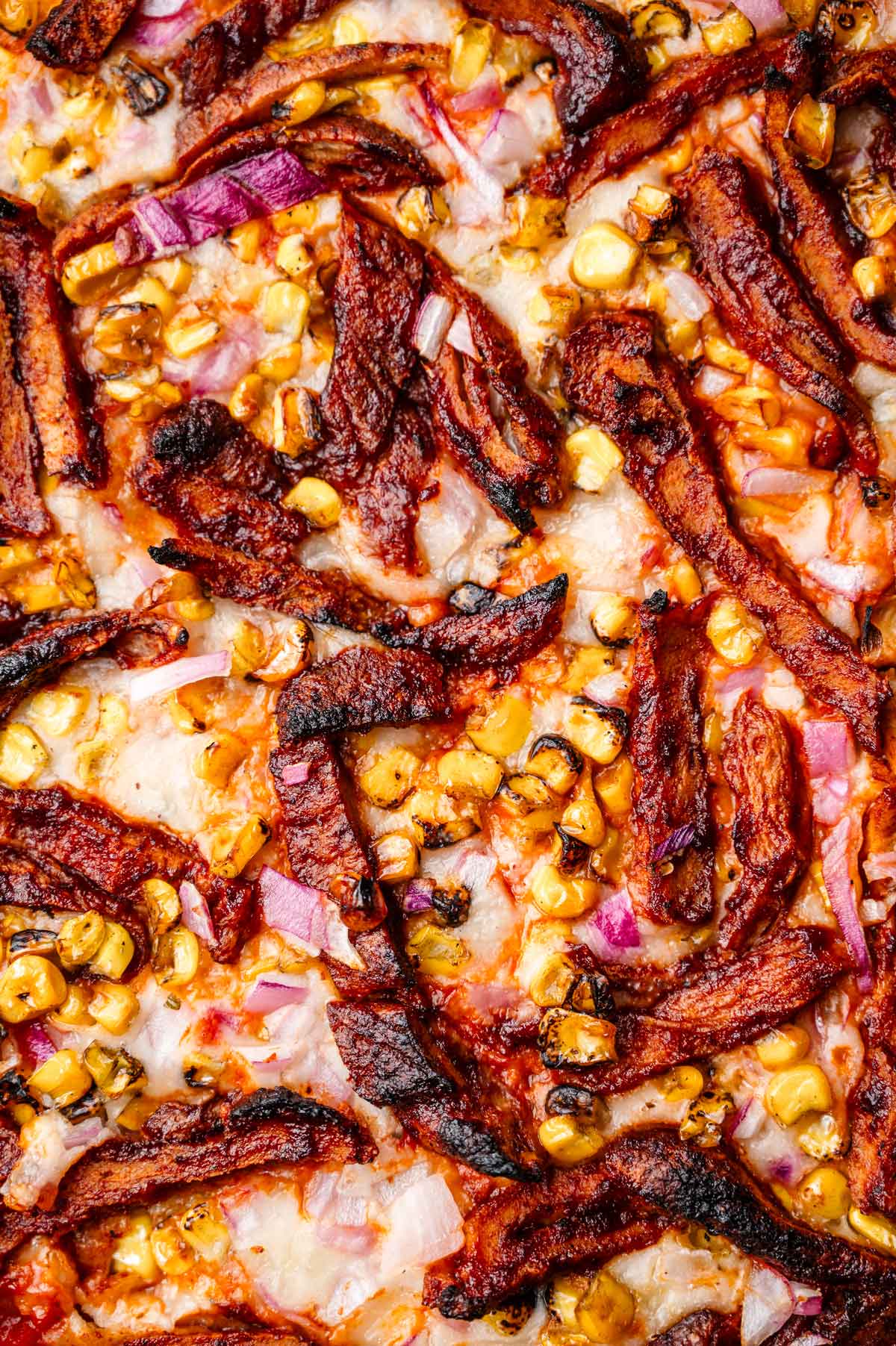 a close up image of the vegan bbq chicken on the pizza.