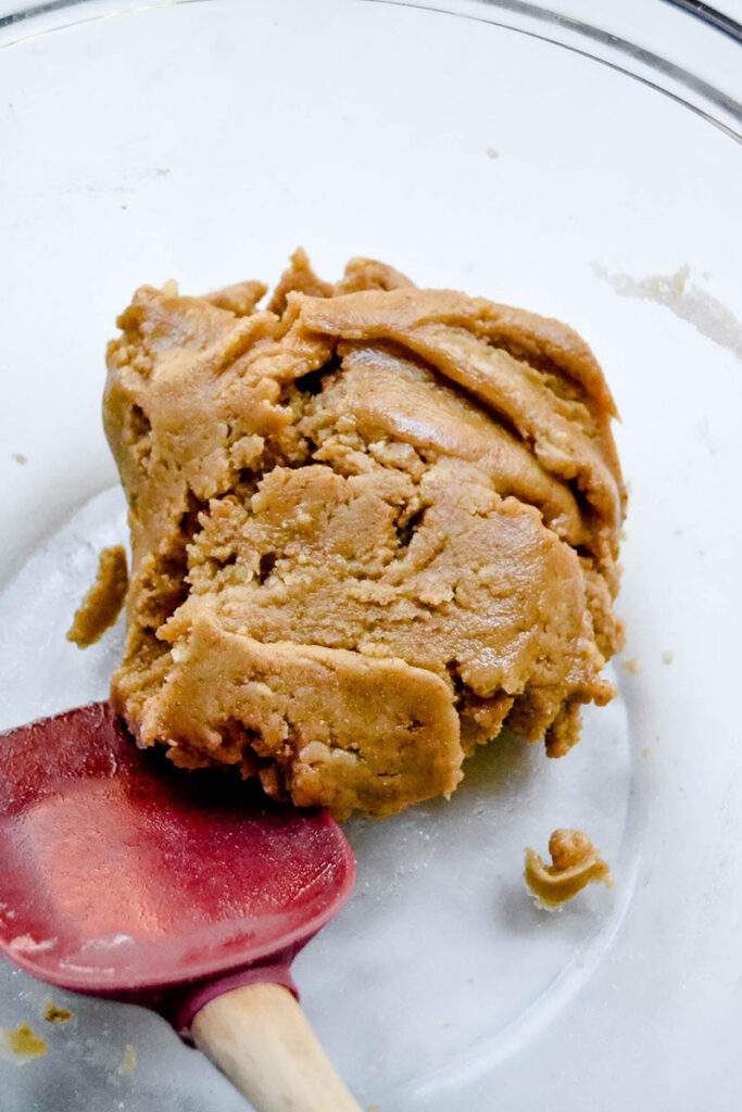 the mixed graham cracker cookie dough in a glass bowl.