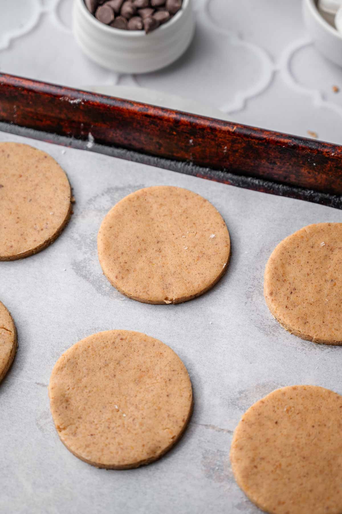 the cut out moon pie cookies ready to bake on a parchment lined baking sheet.