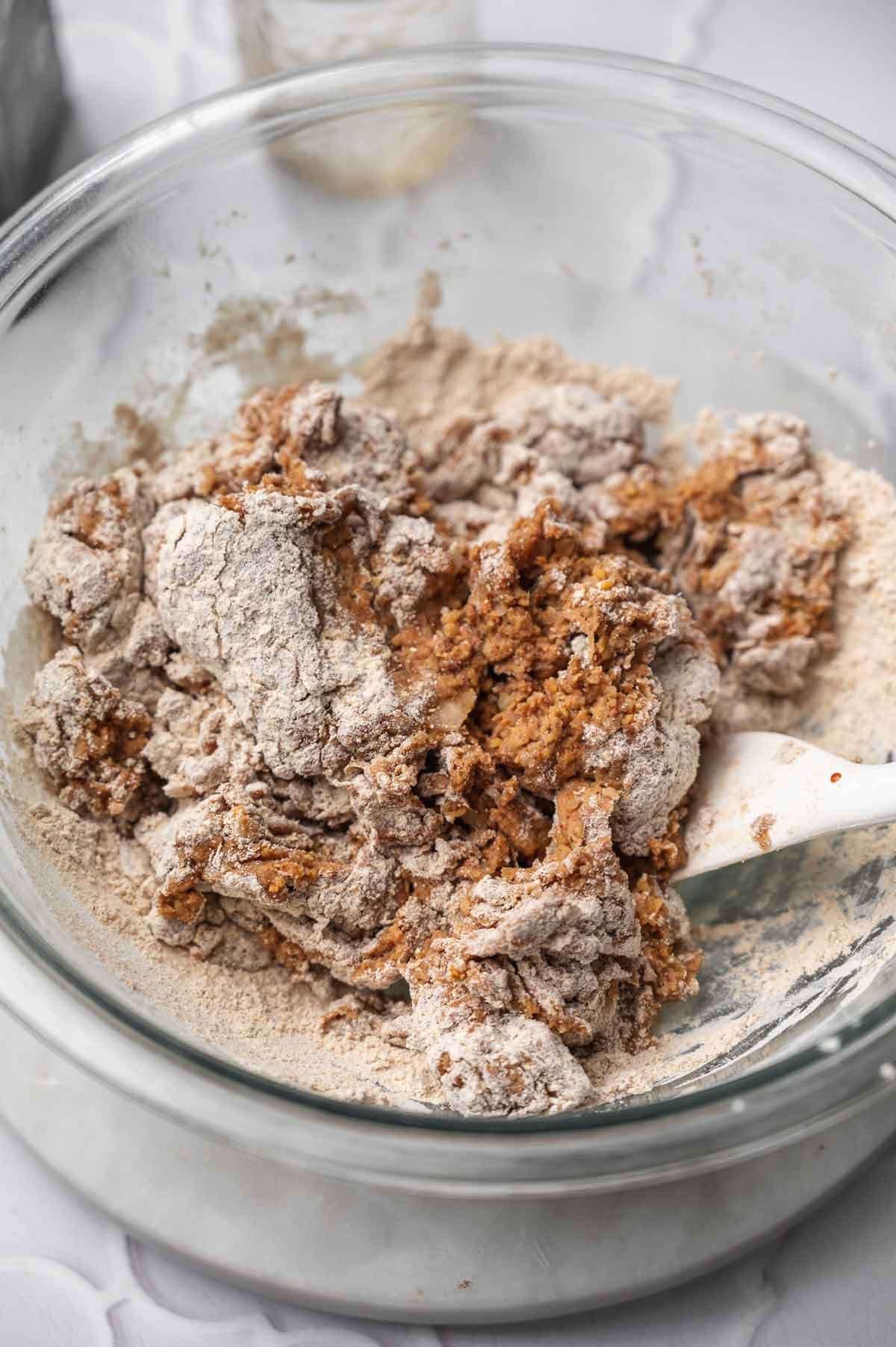 a spatula mixing the seitan beef dough together.