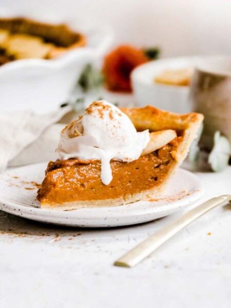 A slice of vegan sweet potato pie on a white dessert plate.