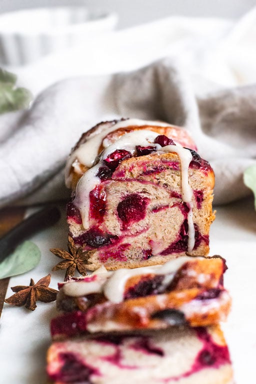 vegan cranberry babka sliced on cutting board