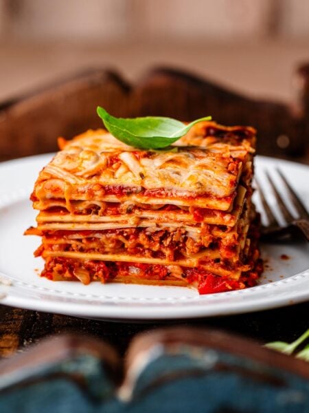 a slice of vegan lasagna on a white plate.
