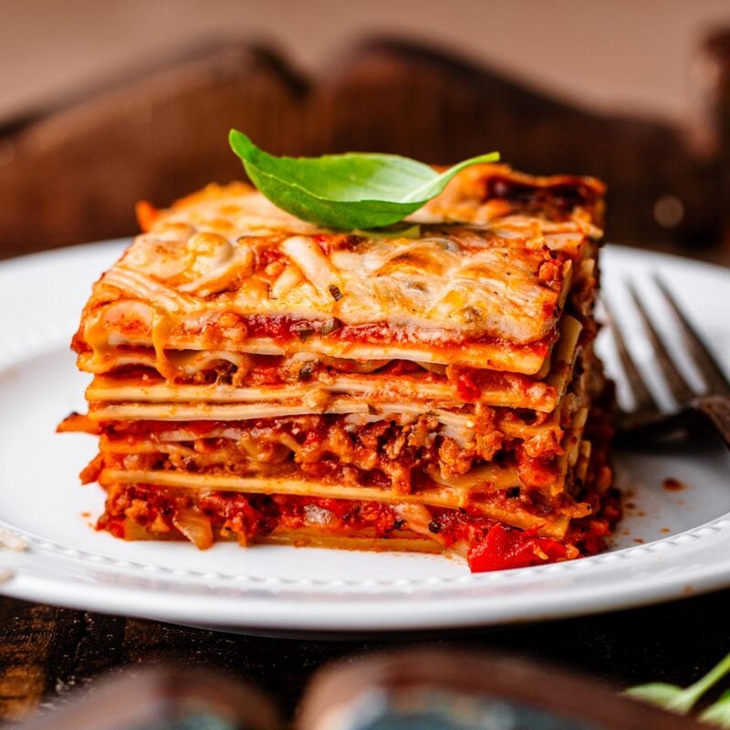 a slice of vegan lasagna on a white plate.