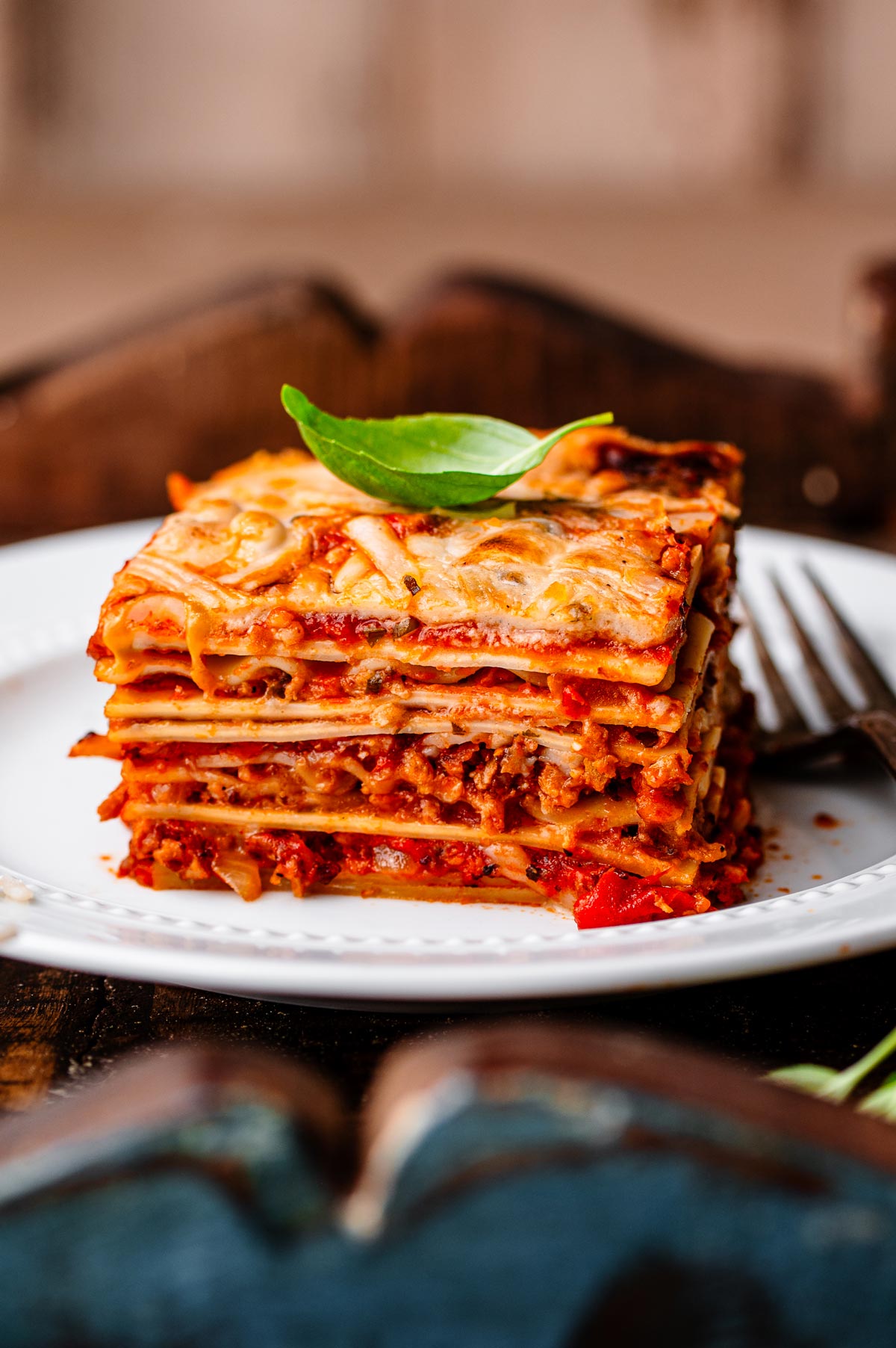 a slice of vegan lasagna on a white plate.