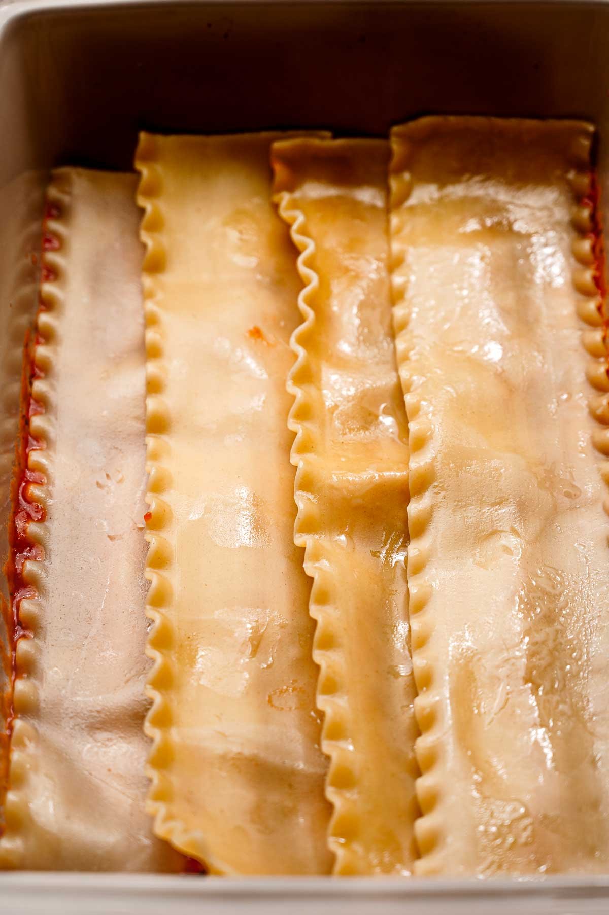 a layer of lasagna noodles in the baking dish.