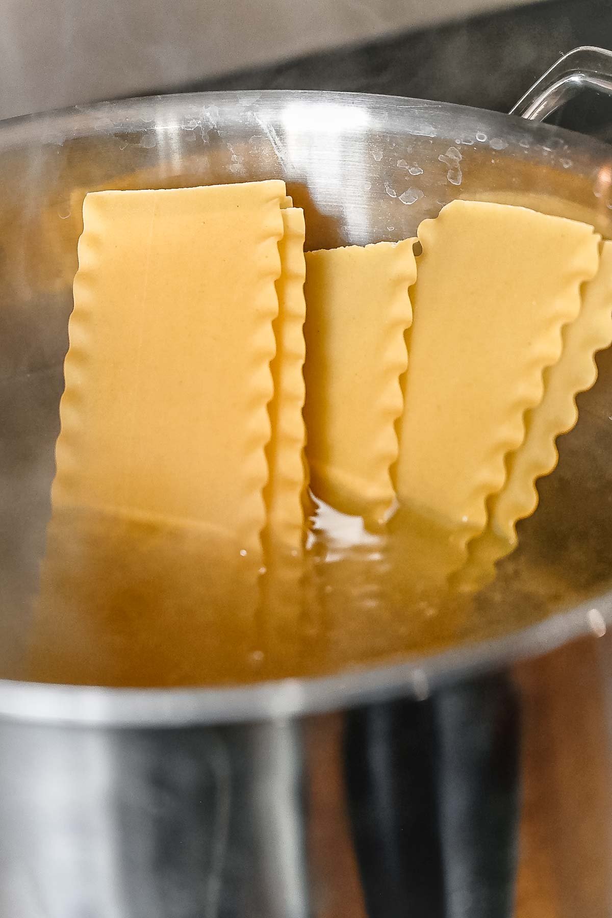 a large pot of boiling water with lasagna noodles.