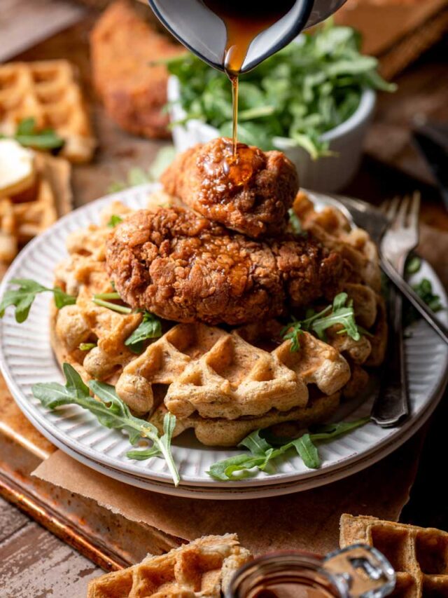 vegan chicken and waffles with a drizzle of maple syrup.