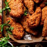 a basket filled with crispy vegan chicken drumsticks that have been airfried.