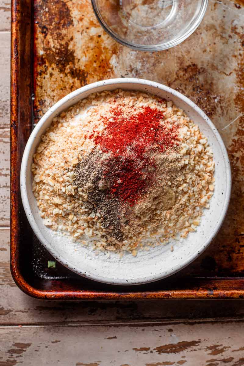 a shallow bowl filled with the breading for the vegan buttermilk chicken.