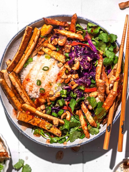a vegan egg roll bowl with crispy wontons and tofu.