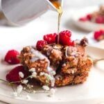 a slice of vegan french toast casserole with syrup being drizzled on top.
