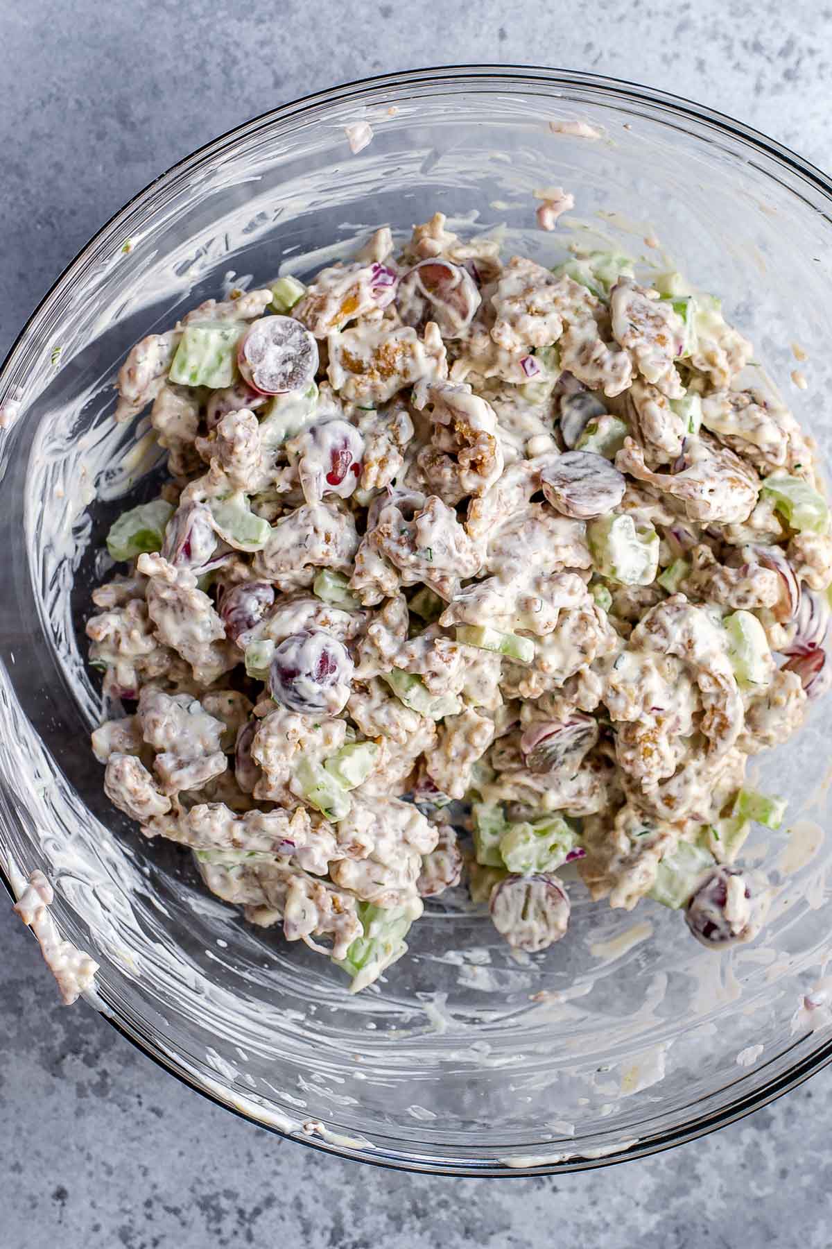 the vegetarian chicken salad ingredients mixed in a large glass bowl.