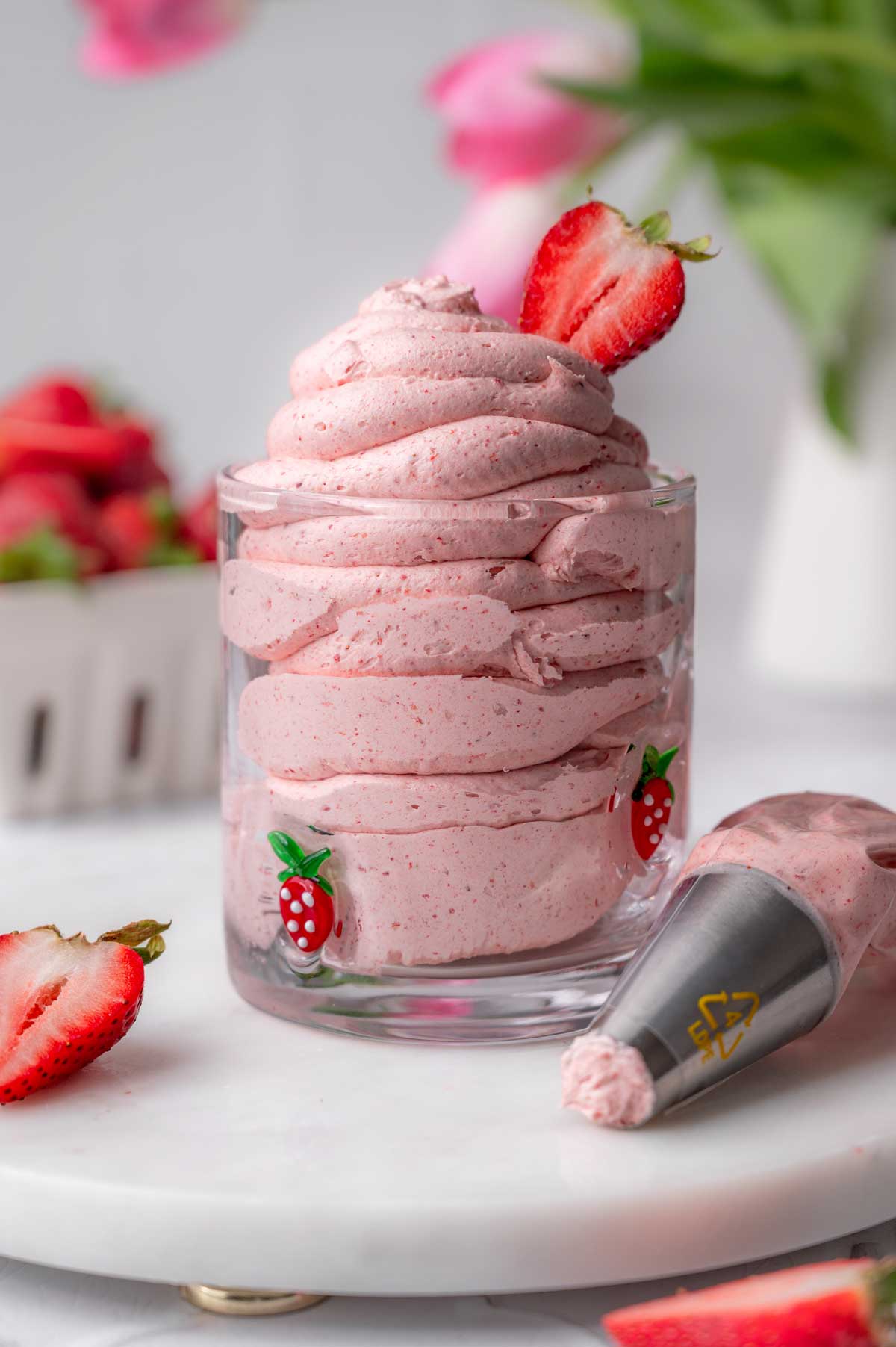 vegan strawberry frosting piped in a glass .