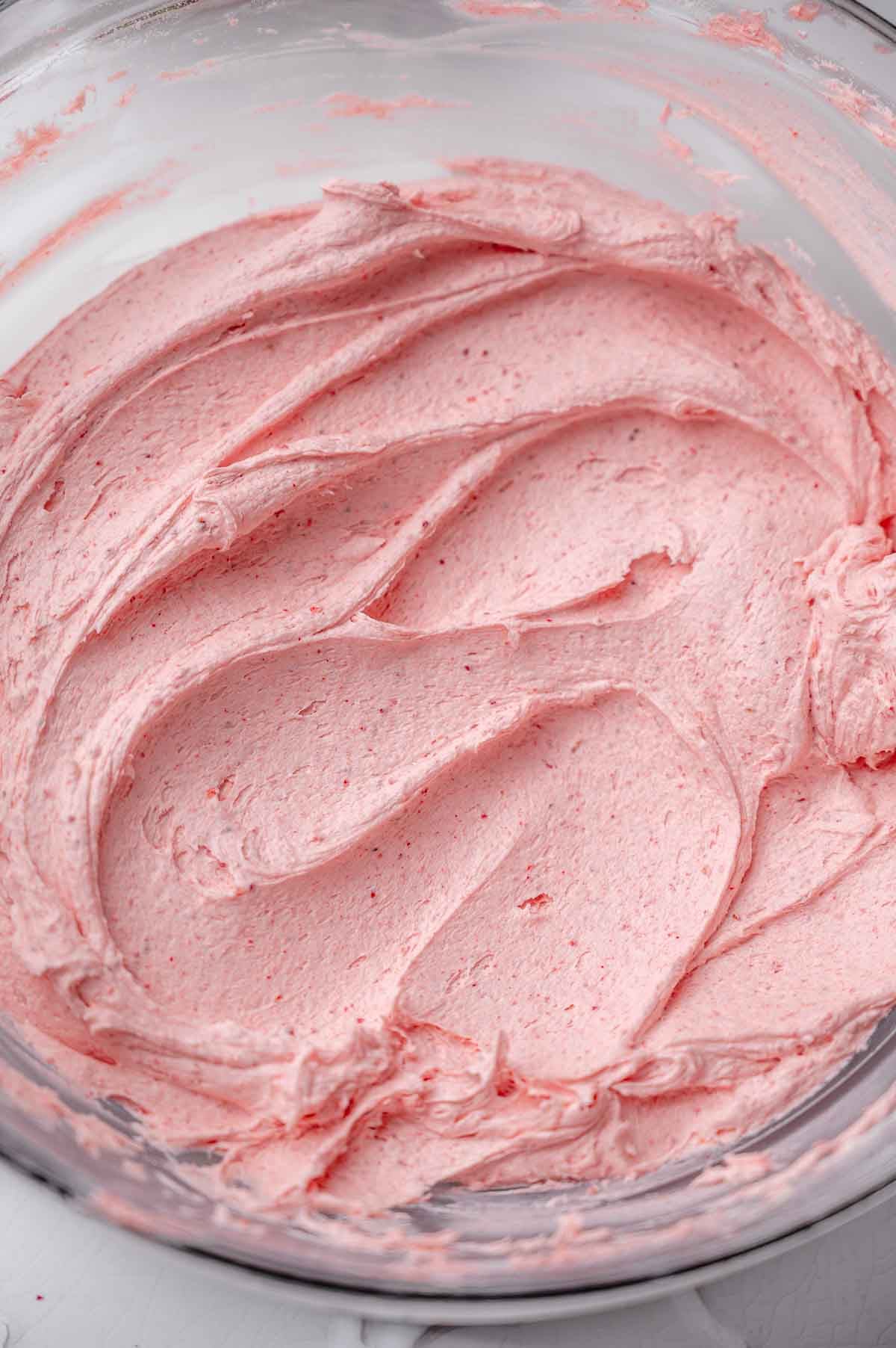 the creamy vegan strawberry buttercream in a large glass bowl.