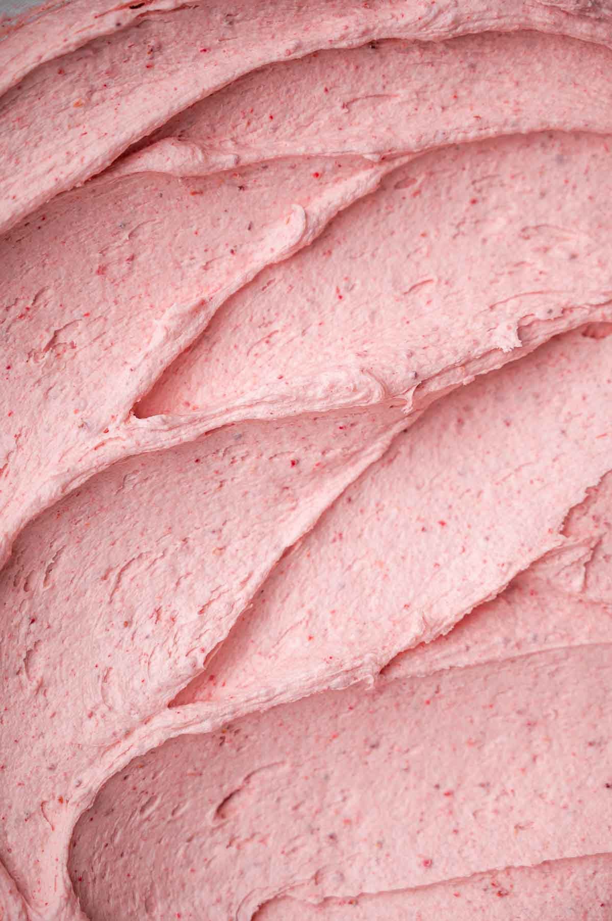 a close up of vegan strawberry buttercream frosting.