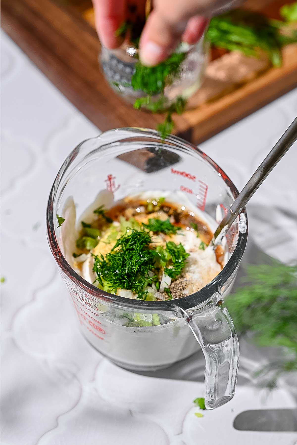 all the vegan ranch ingredients in a glass measuring cup.