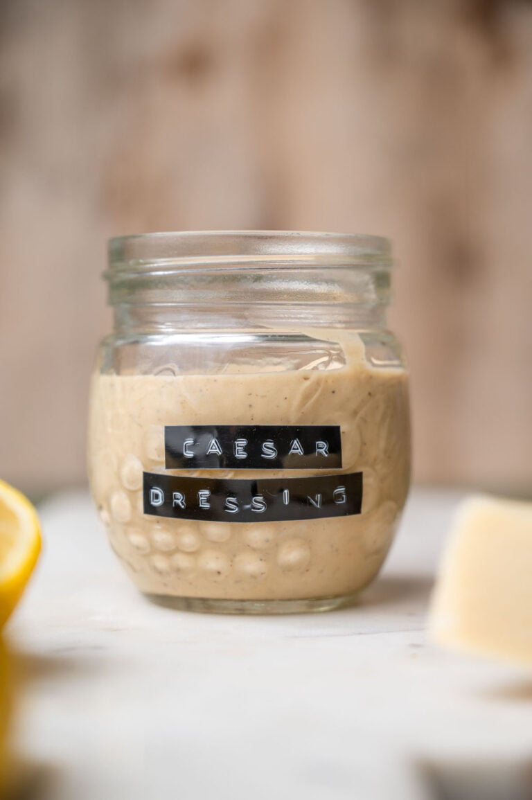 a jar of vegan caesar dressing with a vintage label on the front.