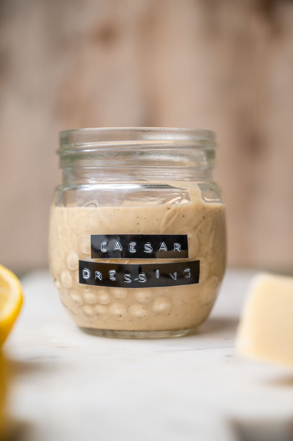 a jar of vegan caesar dressing with a vintage label on the front.