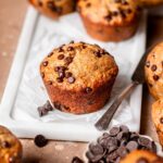 vegan bakery style jumbo banana chocolate chip muffin on a marble tray.