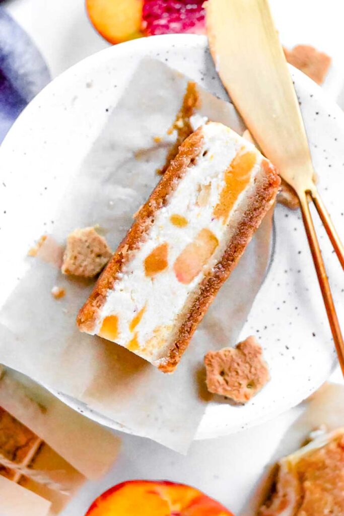 a peaches and cream ice cream sandwich on a white speckled plate.