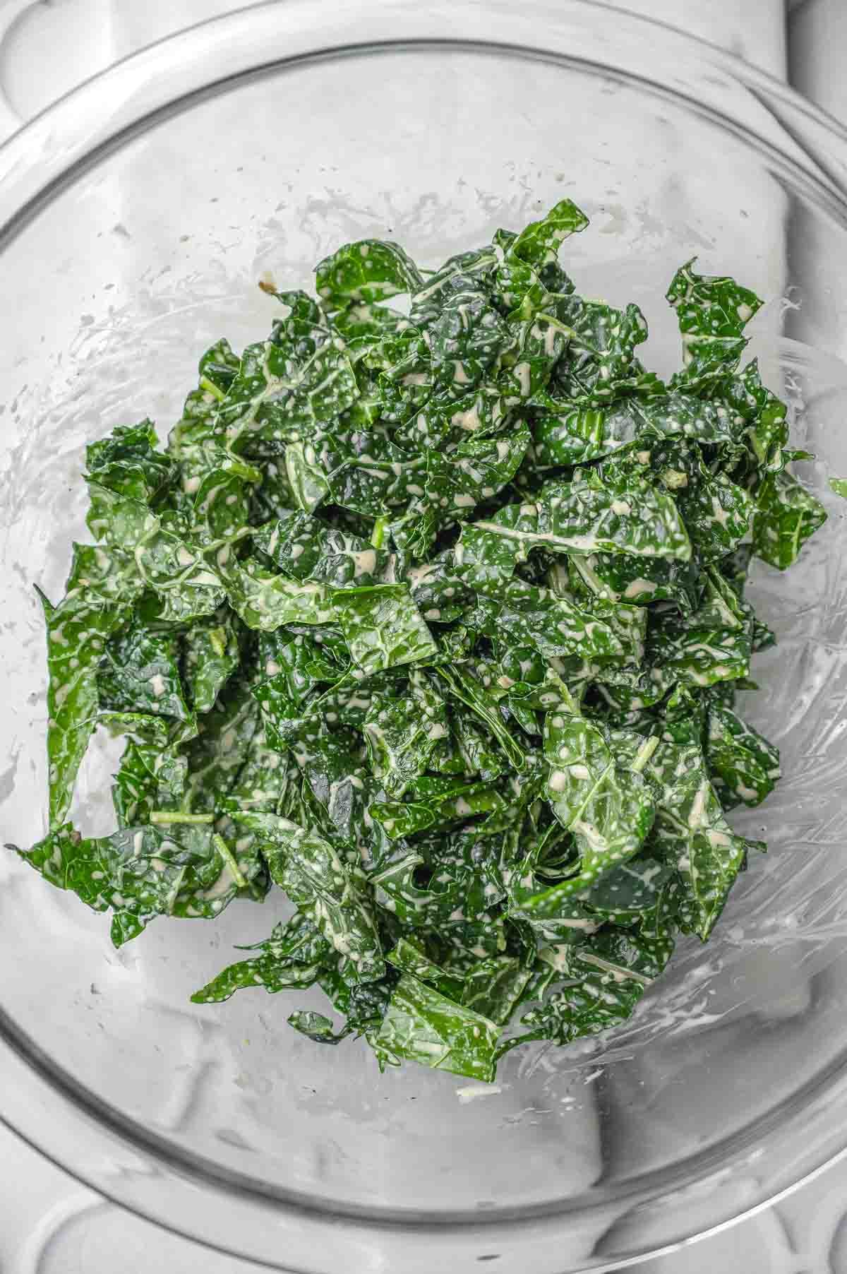 a glass bowl with massaged kale.