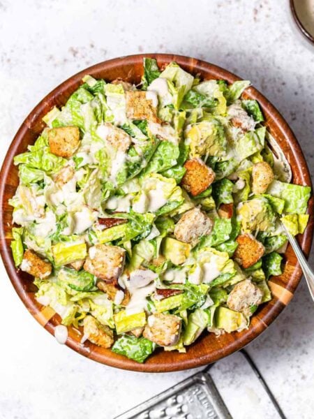 vegan caesar salad in a wooden bowl.