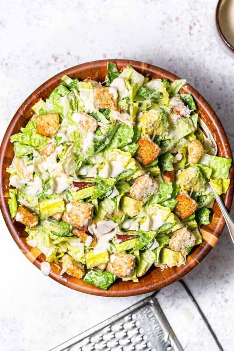 vegan caesar salad in a wooden bowl.