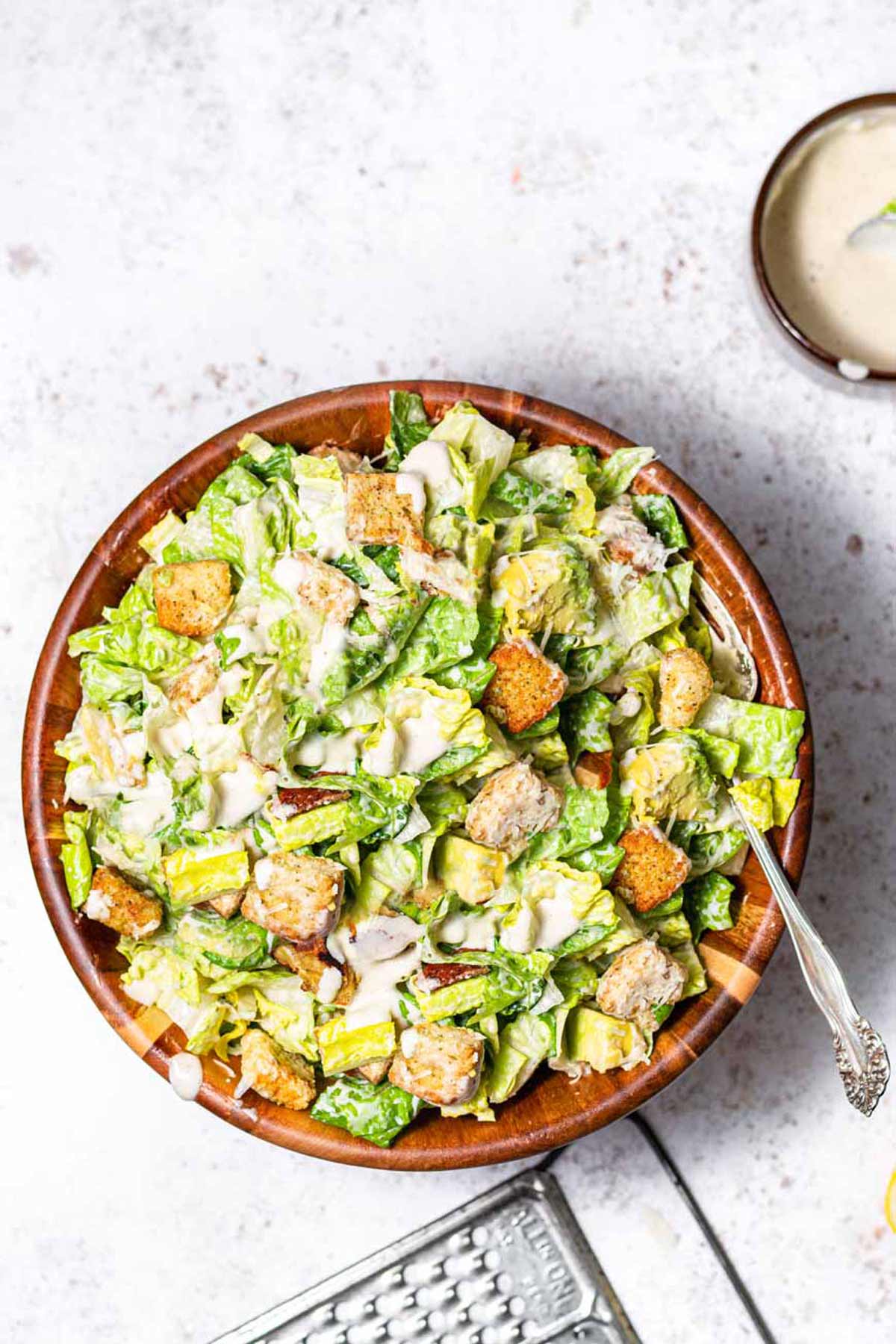 a bowl with a vegan caesar salad with croutons.