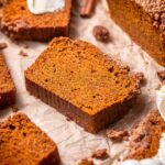 a slice of vegan pumpkin bread with snickerdoodle streusel on top.