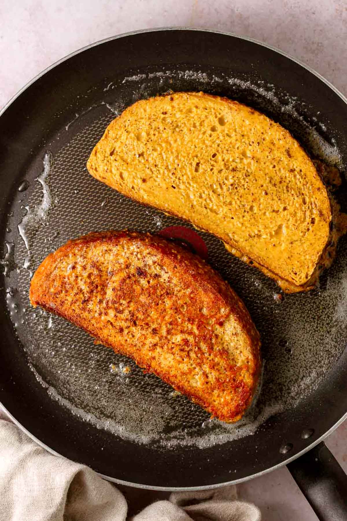 the vegan french toast in a skillet with butter.