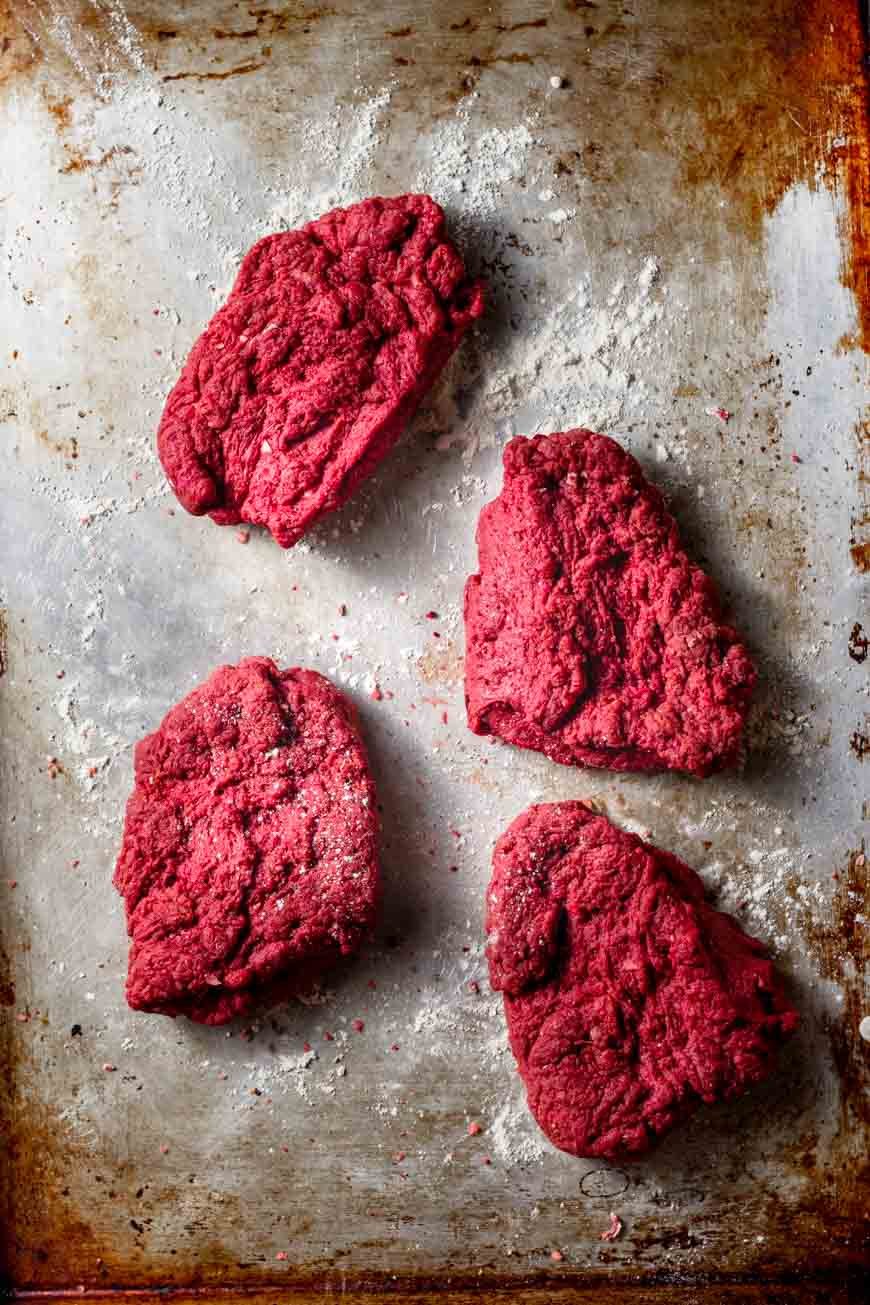 the seitan steak dough divided into four pieces.