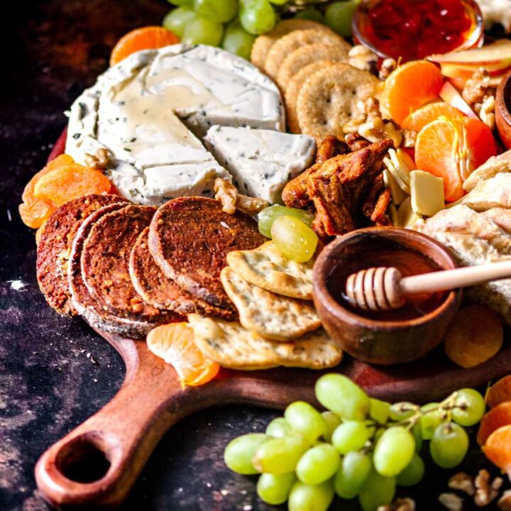 vegan charcuterie board with dairy free cheese and vegetarian meat.