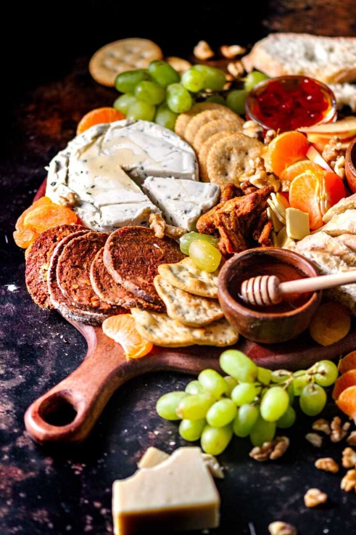 vegan charcuterie board with dairy free cheese and vegetarian meat.