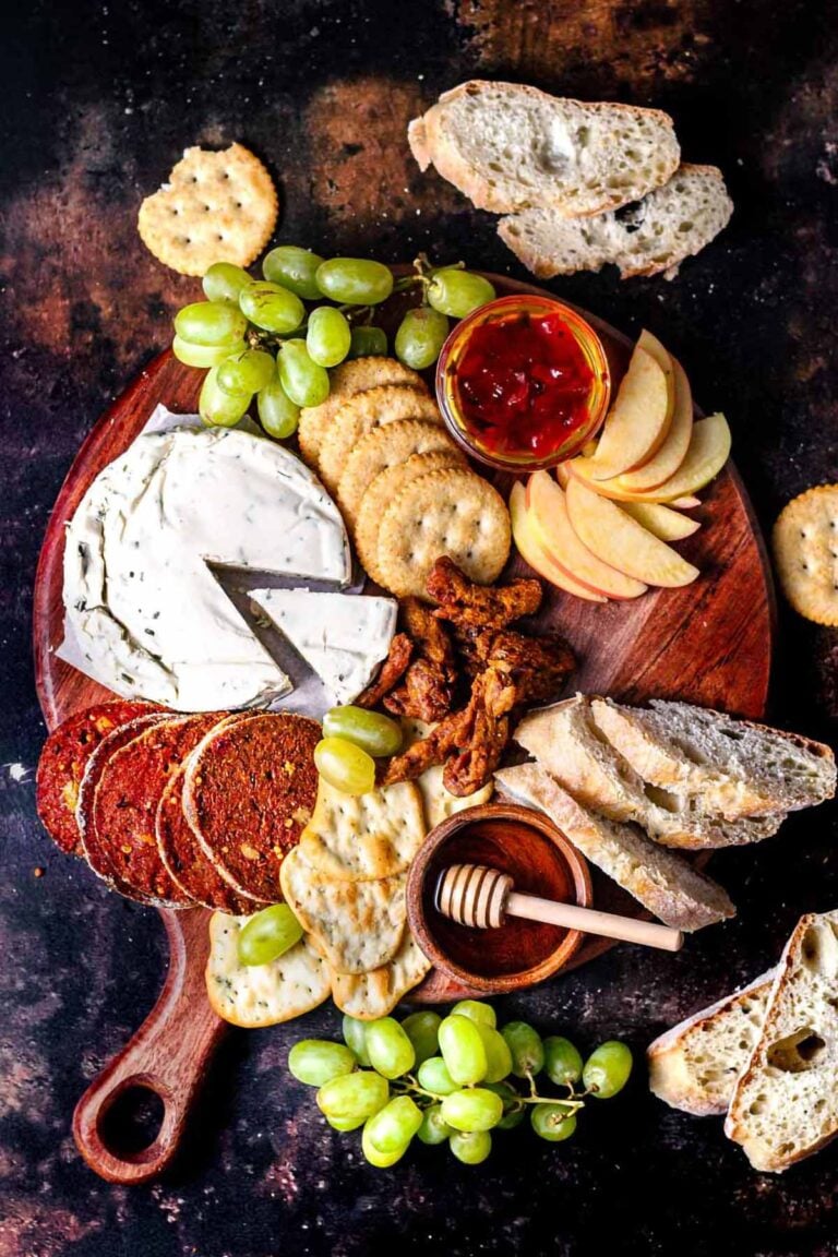 a top view of a vegan charcuterie board with seitan salami.