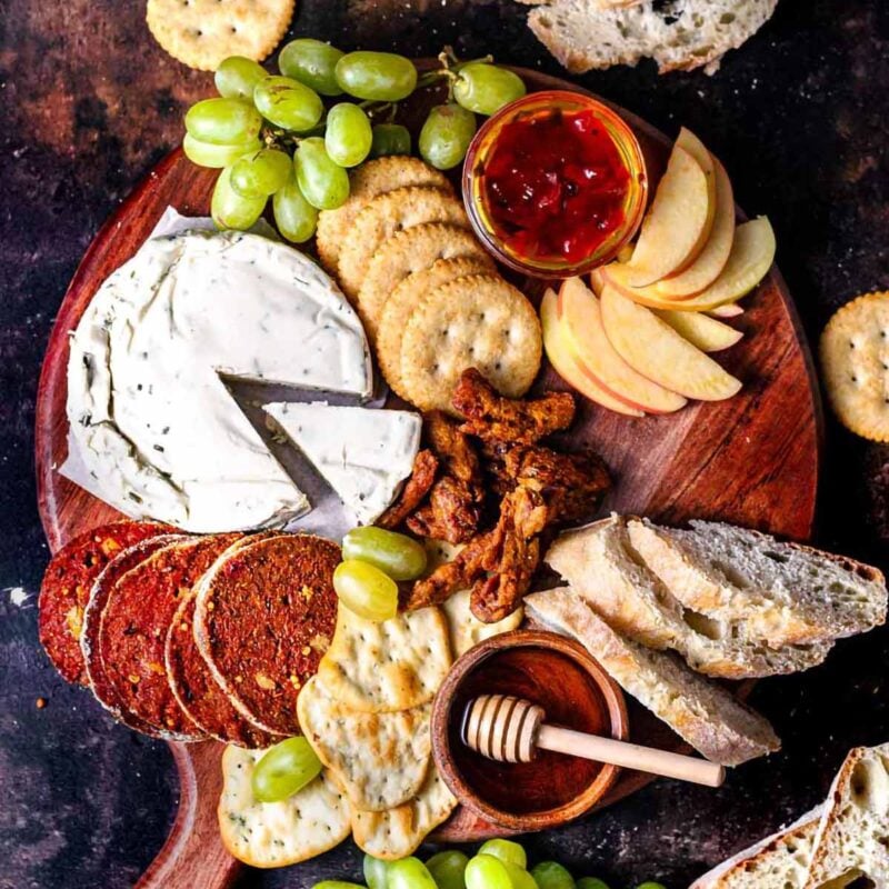 a top view of a vegan charcuterie board with seitan salami.