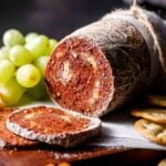 a log of vegan salami coated in a peppercorn crust.