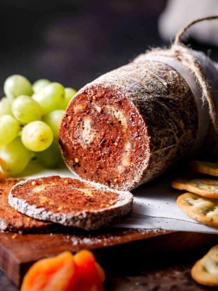 a log of vegan salami coated in a peppercorn crust.