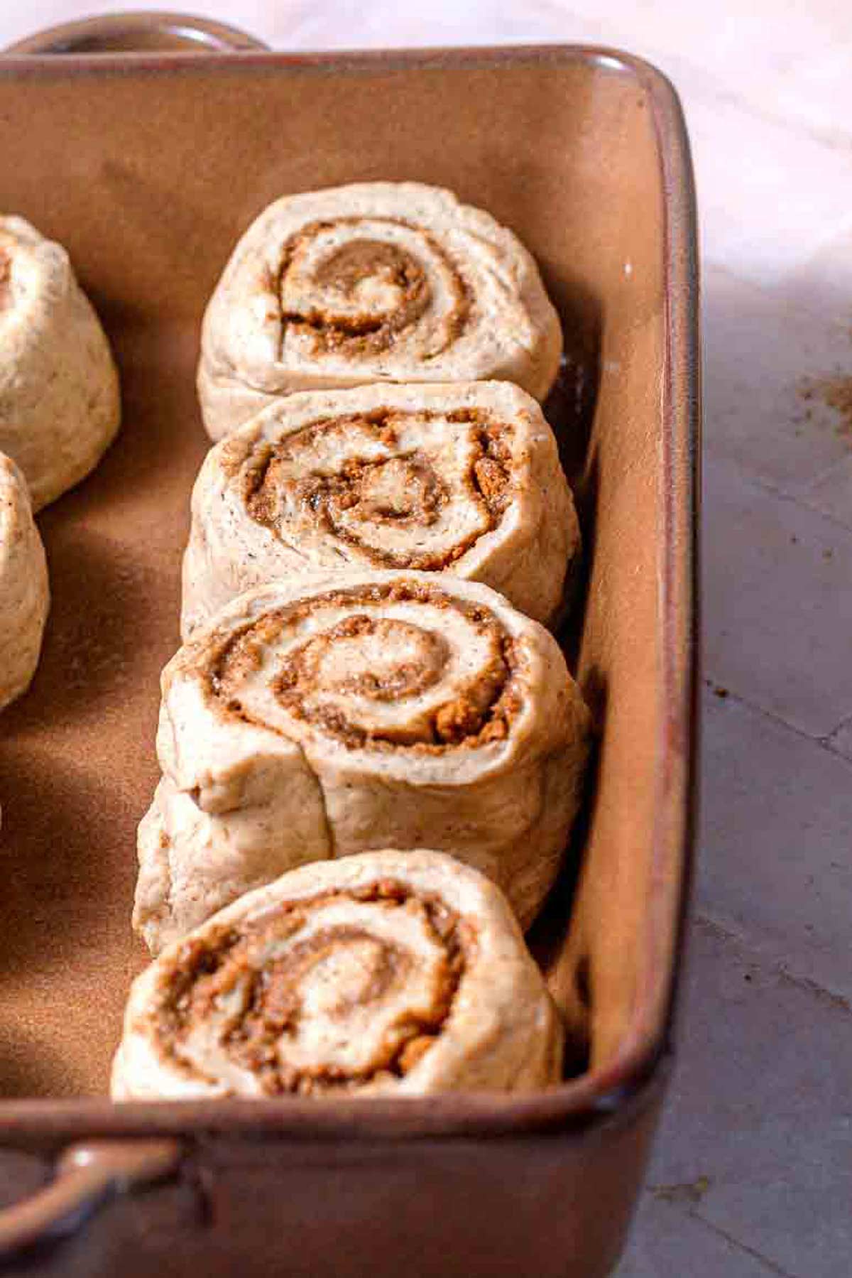 the sliced Biscoff cookie butter cinnamon rolls in a baking dish.