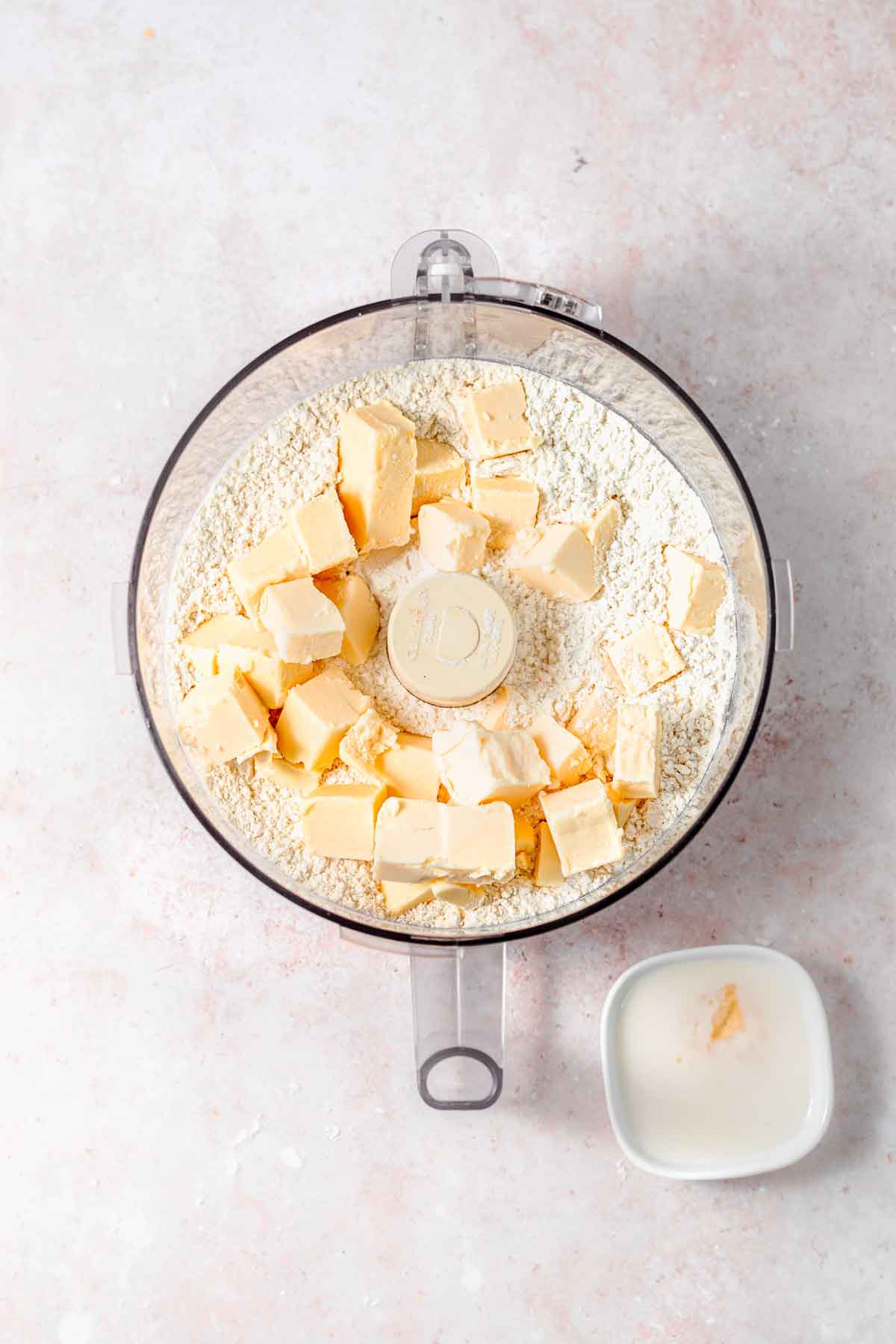 flour and cubed vegan butter in a food processor.