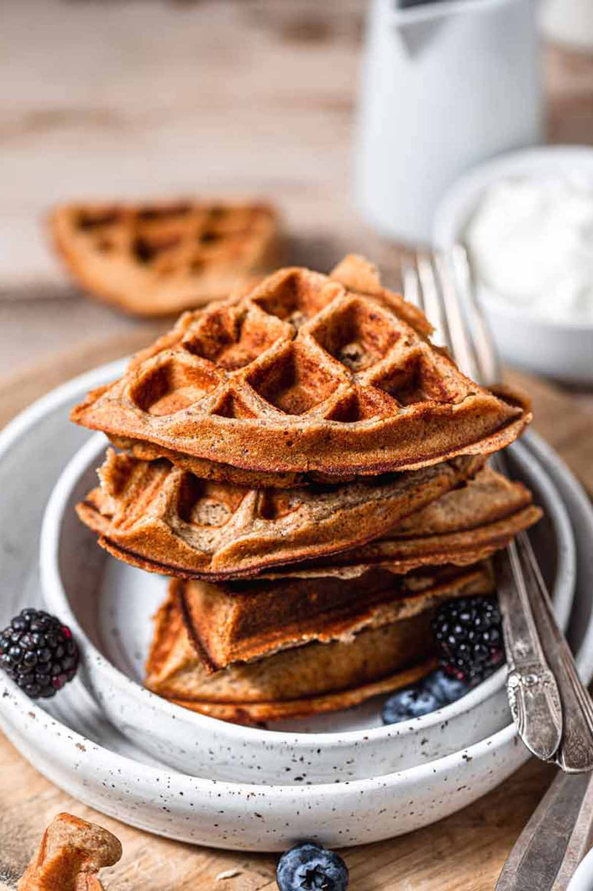 stacked vegan protein waffles on a plate.