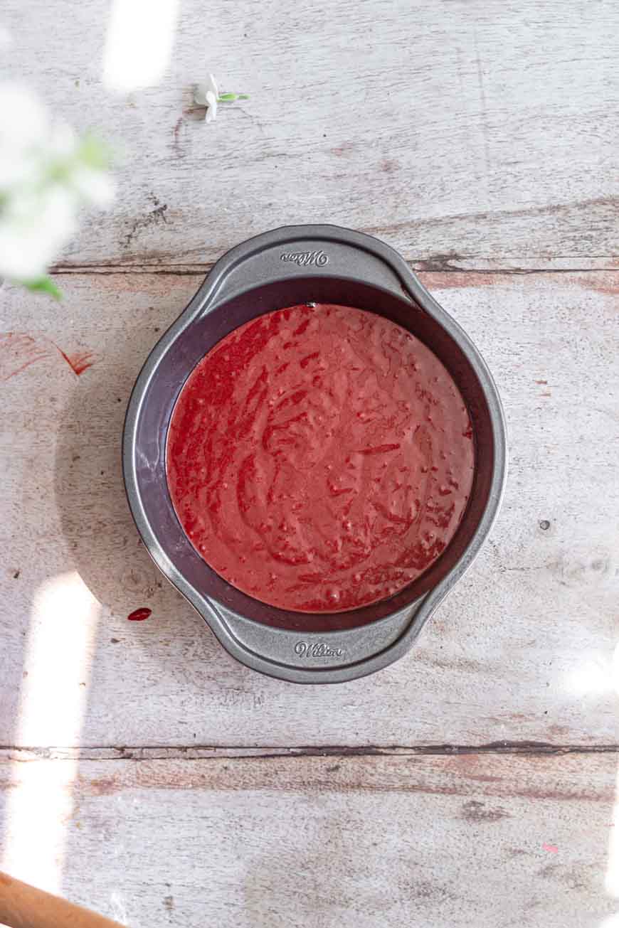 vegan red velvet cake batter in a 6" round pan.