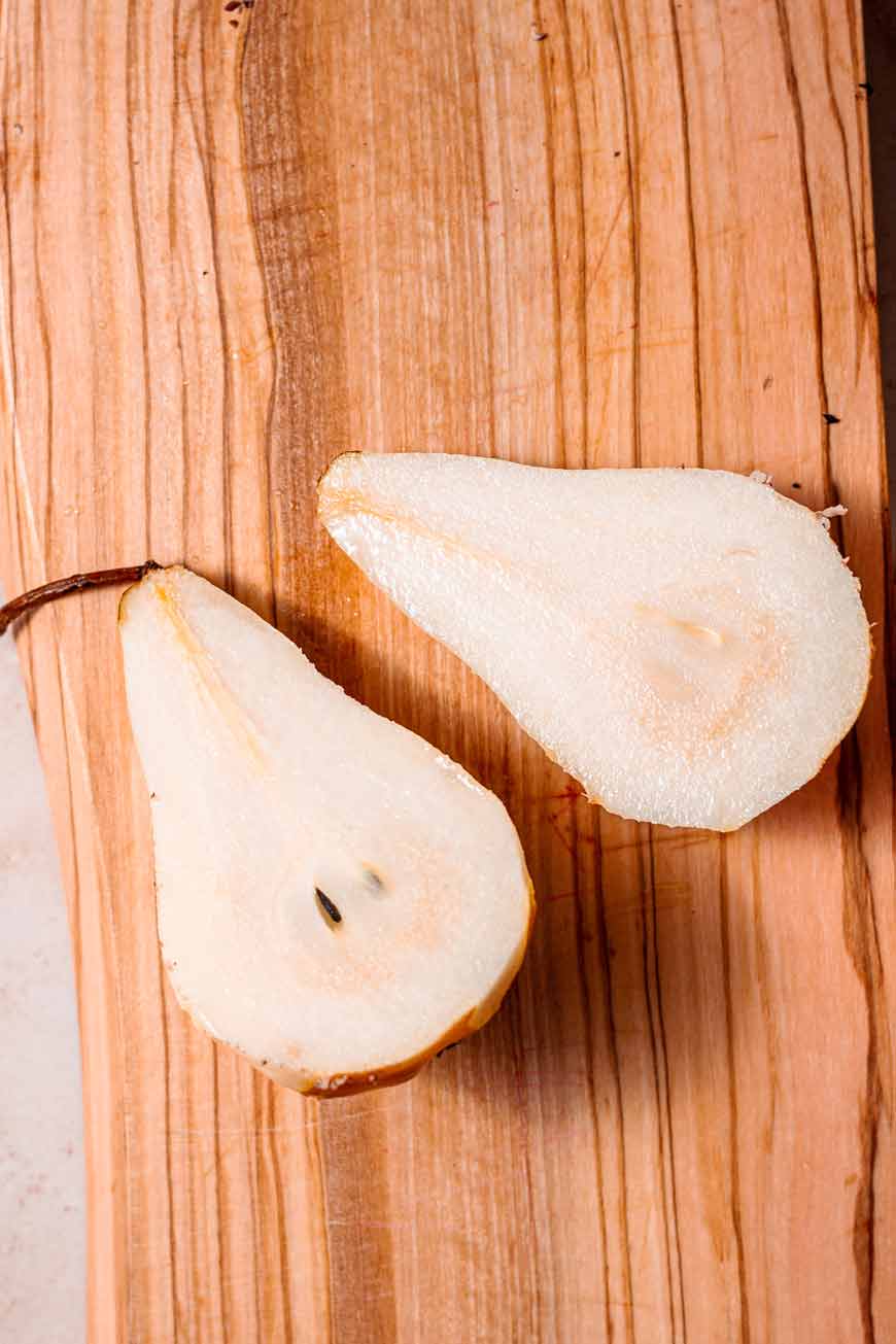 peeled pears on a cutting board.