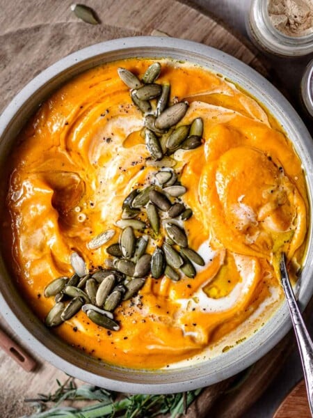 roasted pumpkin and sweet potato soup garnished with pepitas and coconut milk.